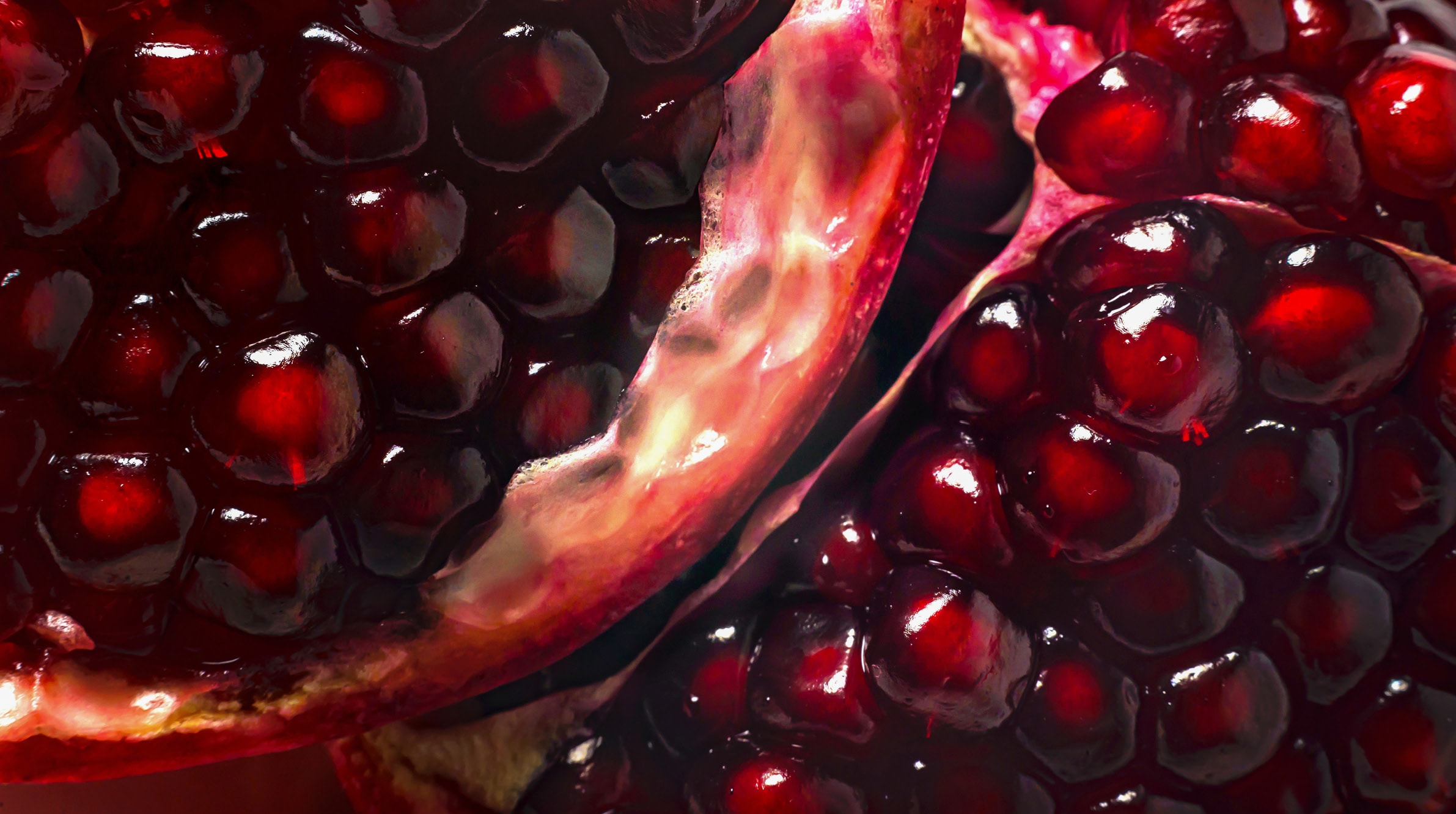 Pomegranate seeds glistening in rich red tones